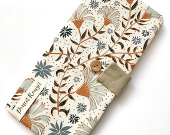 May include: A floral patterned case with a button closure. The case features a cream background with a repeating pattern of flowers in shades of brown, gray, and green. A fabric tag with the text "Poncet Rouget" is sewn on the side. The case is closed with a wooden button.