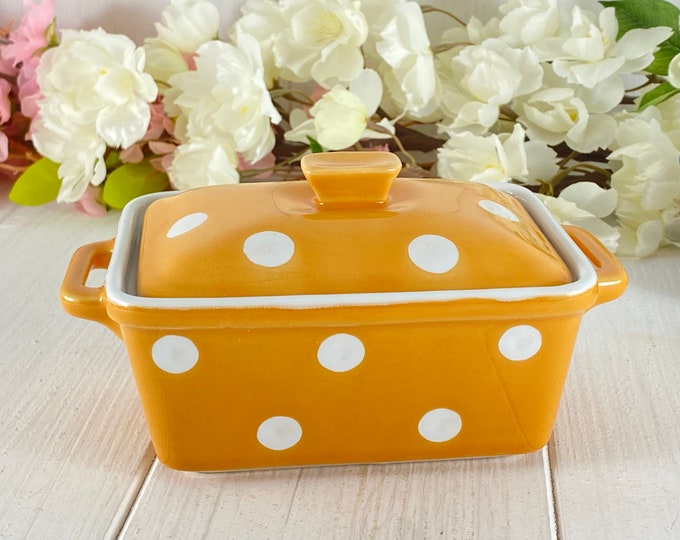 Ceramic butter dish in mustard yellow with white dots