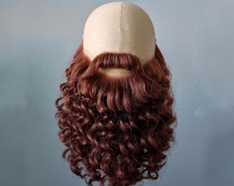 Fake beard and mustache in red color.