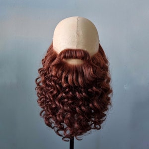 Fake beard and mustache in red color.