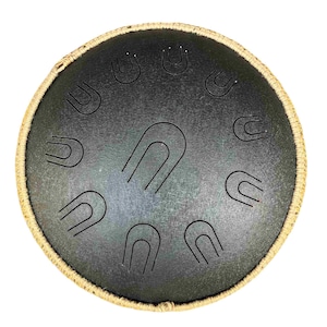 May include: A black steel tongue drum with a rope border. The drum has a series of circular indentations on the surface.