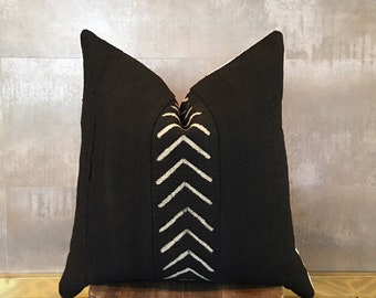 May include: Black and white throw pillow with a geometric pattern of white arrows on a black background.