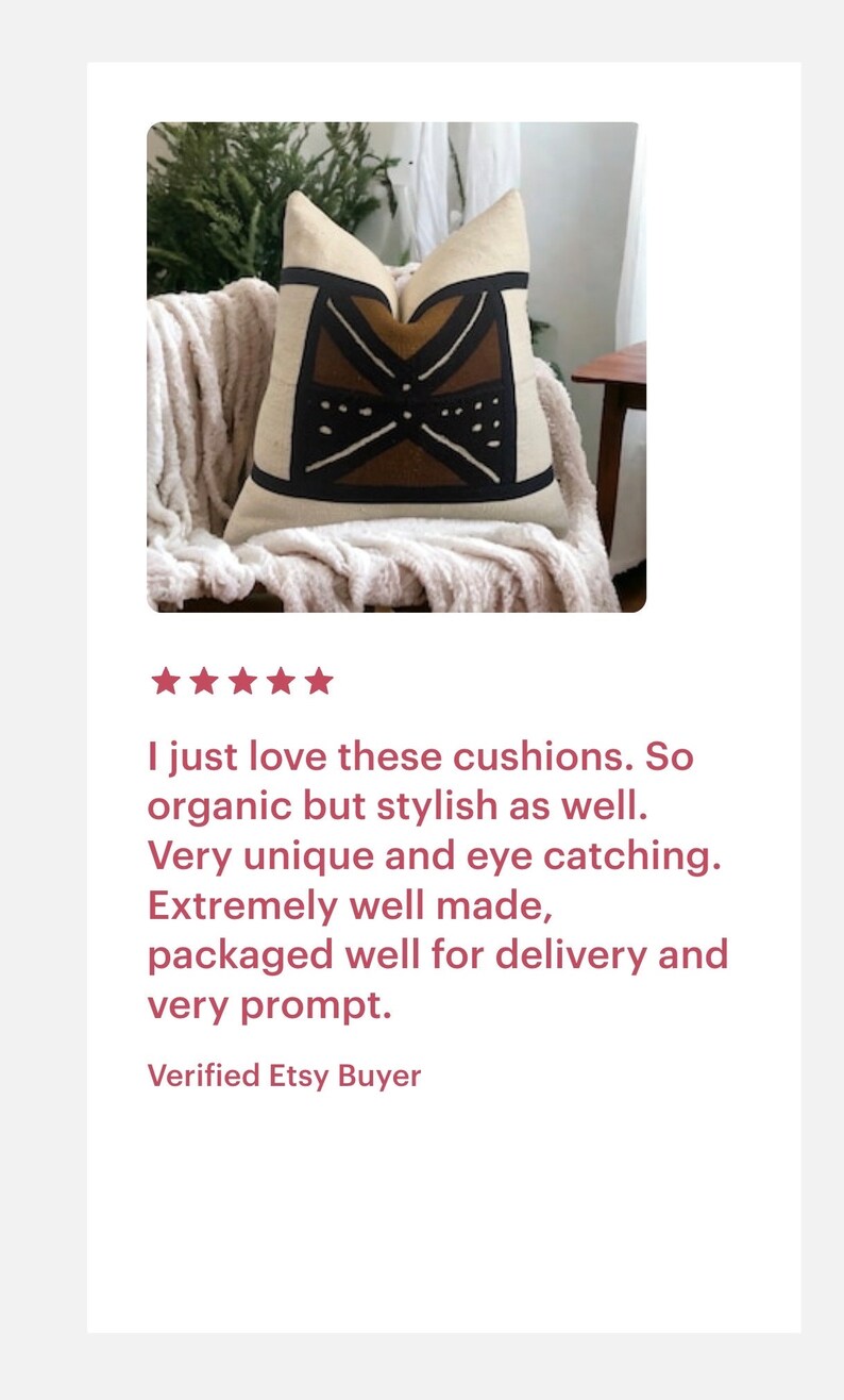 May include: A decorative throw pillow with a geometric pattern in shades of brown, black, and white. The pillow is made of a soft, natural fabric and is sitting on a fluffy white throw blanket.