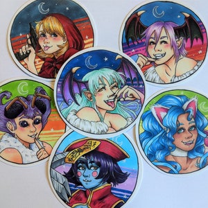 May include: Five round stickers with colorful backgrounds and illustrations of characters with different hairstyles, clothing, and accessories. Each sticker features a crescent moon and stars.