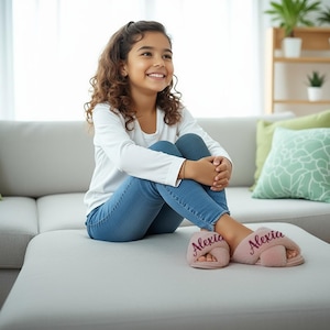 8 year old girl wearing personalized girl slippers with her name on it. These slippers are available in ivory, pink, dusty rose, gray and multicolor for sizes 3T to 3Y.