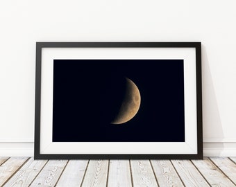 May include: A black and white photograph of a crescent moon in a dark night sky.