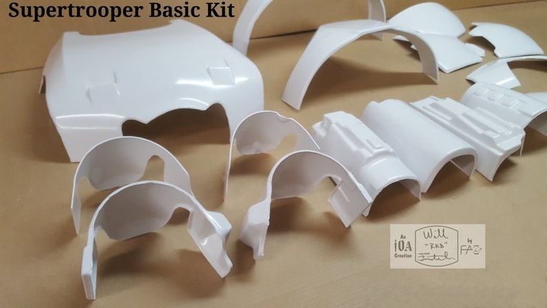 May include: A white plastic kit for building a Supertrooper costume. The kit includes various pieces, including a helmet, chest piece, and shoulder pads.