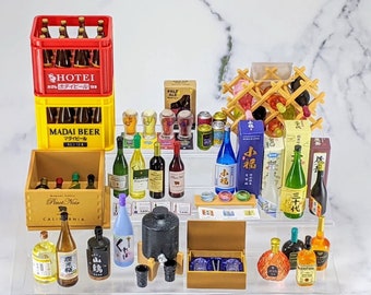 May include: A collection of miniature alcohol bottles, beer crates, and wine racks. The bottles are various shapes and colors, including green, brown, and blue. The beer crates are red and yellow, with Japanese text. A wooden wine rack holds several bottles.