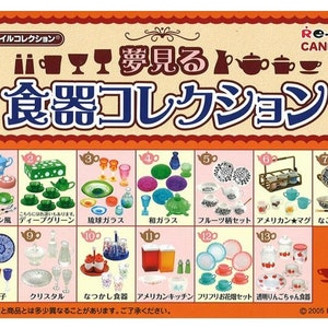May include: A colourful box of miniature teacups, plates, and other tableware. The box is divided into 13 sections, each with a different design. The box is labelled "Re-Ment Candy Toy" and "Dreamy Tableware Collection".