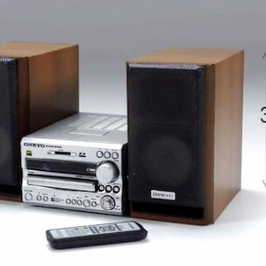 May include: A silver and black stereo system with a CD player and two speakers. The speakers are in wooden enclosures and are 3.2 inches wide. The system includes a remote control.