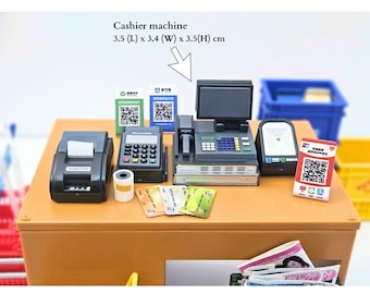 May include: Miniature cashier machine set with a receipt printer, payment terminal, and scanner. Includes credit cards and QR code signs. The cashier machine measures 3.5 cm (L) x 3.4 cm (W) x 3.5 cm (H).