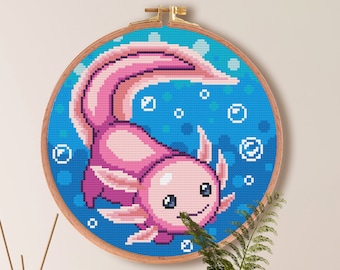 May include: Cross stitch pattern of an axolotl in a blue and white water scene. The axolotl is pink with a white belly and has a happy expression. The pattern is 100 stitches by 100 stitches and measures 7.1 inches by 7.1 inches. The pattern uses 17 DMC colors.