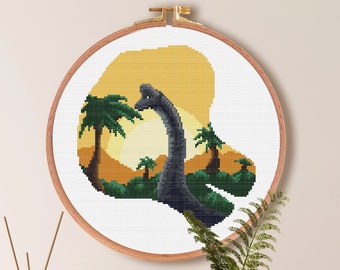 May include: Cross stitch pattern of a dinosaur in a sunset landscape. The pattern is 100 stitches by 100 stitches and measures 7.1 inches by 7.1 inches. The pattern is for Aida cloth with a count of 14. The pattern uses 15 DMC colors.