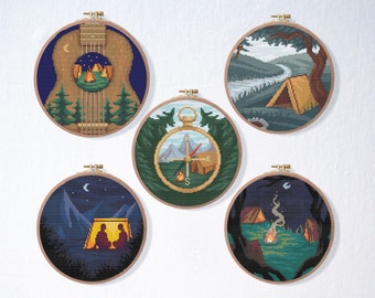 May include: Set of six embroidery patterns featuring camping themes. The patterns include a guitar, a compass, a campfire, and a tent. The patterns are all in a rustic style with brown, green, and blue colors.