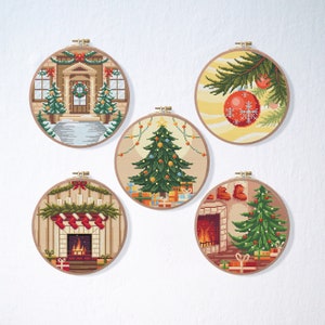 Puede incluir: Cinco aros de bordado redondos con escenas navideñas. Los aros están decorados con una casa con una corona en la puerta, un árbol de Navidad con regalos, una chimenea con calcetines, un árbol de Navidad con adornos y una rama con un adorno rojo.