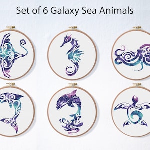 May include: Set of six galaxy sea animal embroidery patterns. Each pattern is displayed in a round wooden embroidery hoop. The animals are a manta ray, seahorse, octopus, dolphin, orca, and sea turtle. The patterns are in shades of purple, blue, and green.