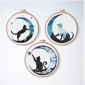 May include: Three embroidery hoop art pieces featuring black cat silhouettes on a crescent moon with blue and white watercolor backgrounds.