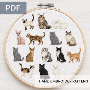 May include: A round wooden embroidery hoop containing white fabric with a hand-stitched pattern of fifteen various cat breeds in different colors and poses. The text PDF and HAND EMBROIDERY PATTERN are visible on the image.