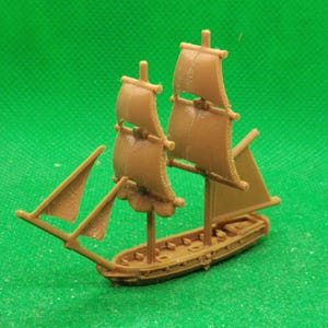 May include: A brown wooden model ship with three sails. The ship has a long, narrow hull and a small deck. The sails are all raised and billowing in the wind.