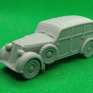 Peut inclure: Une voiture miniature grise avec une carrosserie en bois et un toit. La voiture a quatre portes et quatre roues. La voiture est une familiale.