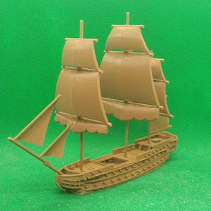 May include: A brown wooden model ship with sails. The ship has a single mast and multiple sails. The ship is on a green background.