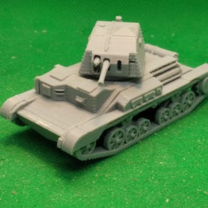 May include: A grey model tank with a detailed turret, gun, and tracks. The miniature tank is set against a green background, showcasing its design. The tank is approximately 15 cm long.
