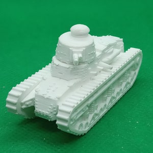 May include: A white plastic model of a French tank with a turret and tracks.