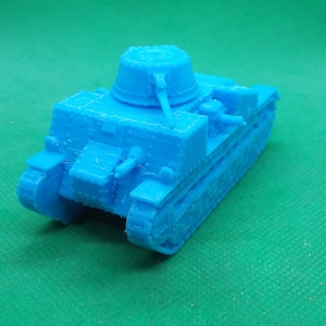 May include: A light blue toy tank model with a turret and two cannons. The tank has a detailed design and is made of plastic.