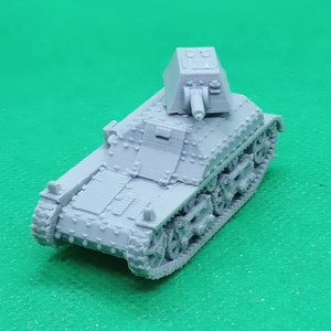 May include: A grey plastic model of a French light tank with a turret and tracks.
