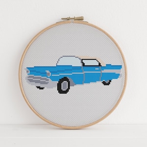 May include: A blue vintage car cross-stitch pattern in a wooden embroidery hoop.