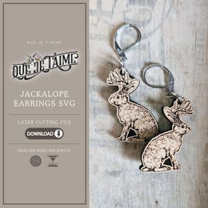 May include: Wooden jackalope earrings with silver-colored leverback closures. The earrings feature a detailed laser-cut design of a jackalope, a mythical creature with the body of a rabbit and antlers. The image also includes text that says "QUE JE TAIME" and "JACKALOPE EARRINGS SVG".
