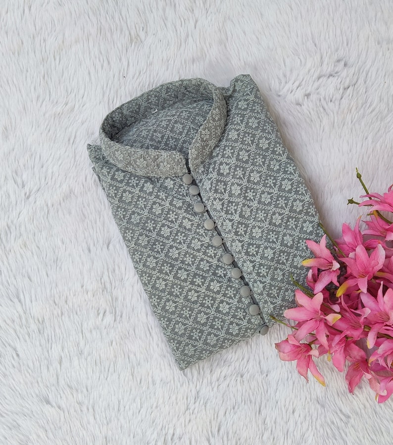 Pode incluir: Uma kurta cinza bordada com um padr&atilde;o floral branco e fechos de bot&atilde;o.