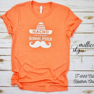 May include: Orange t-shirt with a white graphic of a sombrero and mustache with the text "Nacho Average School Psych".