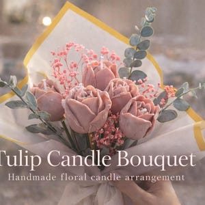 May include: A bouquet of handmade tulip candles in shades of pink and mauve, wrapped in white and yellow paper. The arrangement includes sprigs of pink filler flowers and green foliage. The text "Tulip Candle Bouquet" is visible.