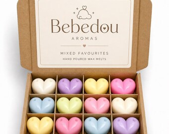 May include: An open cardboard box displaying sixteen heart-shaped wax melts in pastel shades. The box is labelled "Bebedou Aromas" and the text "Mixed Favourites" and "Hand Poured Wax Melts" is also visible. The wax melts are arranged in four rows of four.