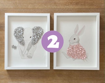 May include: Two framed prints with animal illustrations. The left print features a gray elephant with silver flower embellishments. The right print features a white rabbit with pink flower embellishments.