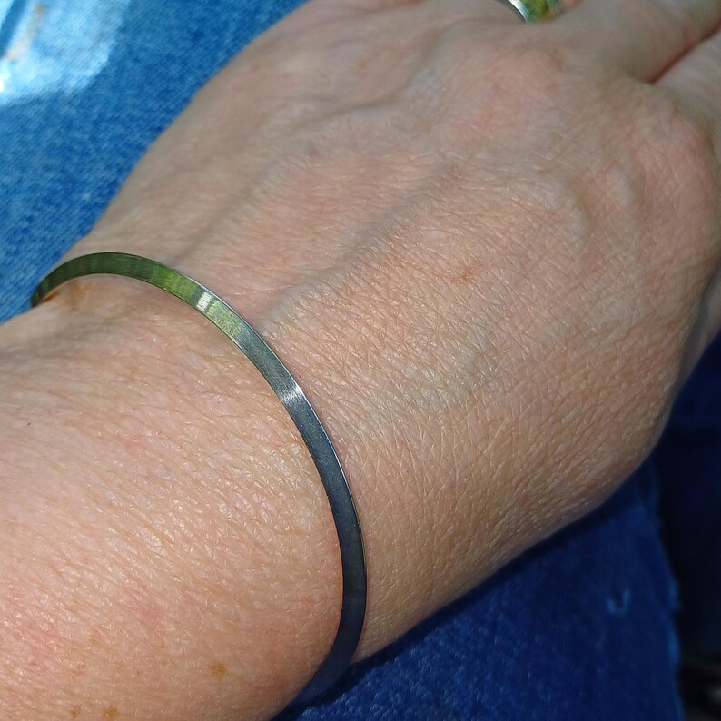 solid silver triangular profile bracelet shown on wrist