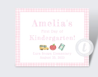 May include: A pink and white gingham background with a white card. The card has the text "Amelia's First Day of Kindergarten!" with a yellow school bus, a red apple, and a green and blue notebook. The card also has the text "Eura Brown Elementary August 25, 2023".