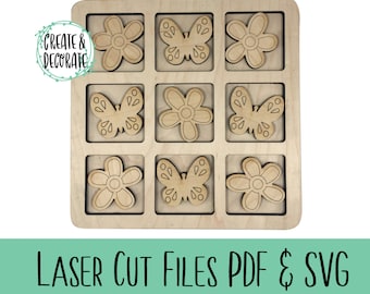 May include: A wooden game board with nine squares, each containing a cutout of either a butterfly or a flower. The board is made of light wood and has a natural finish. The butterflies and flowers are cut out of the same wood and have a simple design.