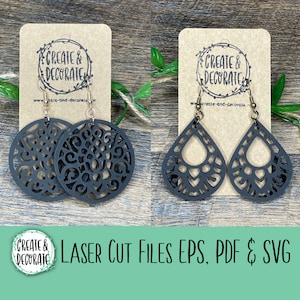 May include: Two pairs of laser cut earrings. One pair is round with a black filigree design. The other pair is teardrop shaped with a black filigree design. The earrings are displayed on brown card stock with the text "CREATE & DECORATE" on each card.
