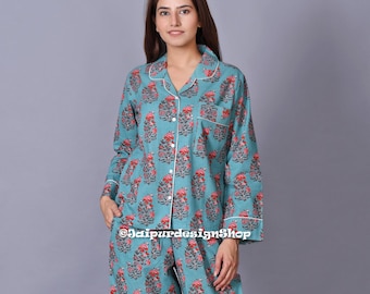 May include: A teal blue pajama set with a floral print. The top has a collared neckline and long sleeves. The pants have a straight leg.