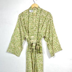 May include: A green and cream floral print silk robe with a tie belt.