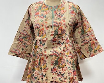 May include: A beige, floral-print top with three-quarter sleeves. The top features a round neckline with a light blue trim and a gathered waist. The floral pattern includes red, yellow, and green elements.