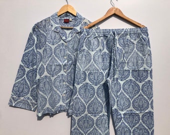May include: A blue and white patterned pajama set with a long-sleeved shirt and pants. The shirt has a button-up front and a collar.