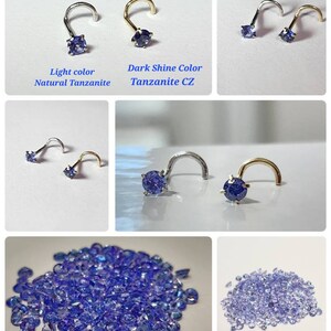 May include: Close-up of a variety of Tanzanite gemstones. The gemstones are a deep blue-purple color and are arranged in a pile. The image also shows a nose ring with a Tanzanite gemstone. The text "Light color Natural Tanzanite", "Dark Shine Color Tanzanite CZ", "Shine Dark CZ Tanzanite", and "Natural Tanzanite" is visible in the image.