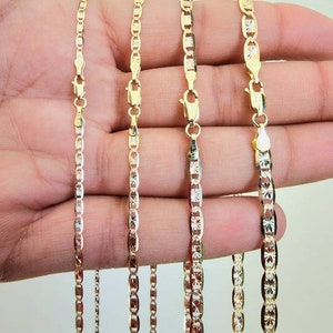 May include: Four gold chains of different widths, 2.10 mm, 2.60 mm, 3.30 mm, and 4.20 mm, are shown in a hand. The chains are all made of a delicate, patterned design.