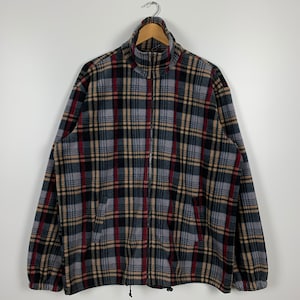 May include: A gray, black, red, and beige plaid fleece jacket with a zipper closure.