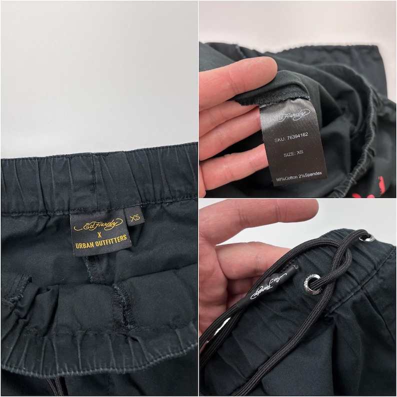 May include: Black drawstring pants with an elastic waistband. The pants have a tag that says "Ed Hardy X Urban Outfitters" and another tag with the size "XS". The pants are made of 98% cotton and 2% spandex.