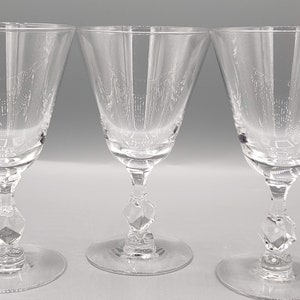 May include: Three clear glass wine glasses with a diamond-shaped stem.