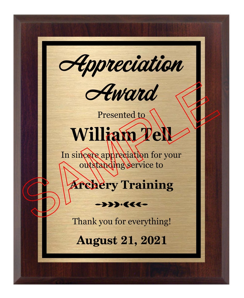 May include: A gold plaque with a black border and a mahogany frame. The plaque reads "Appreciation Award" and is presented to "William Tell" for "outstanding service to Archery Training". The date "August 21, 2021" is printed at the bottom.